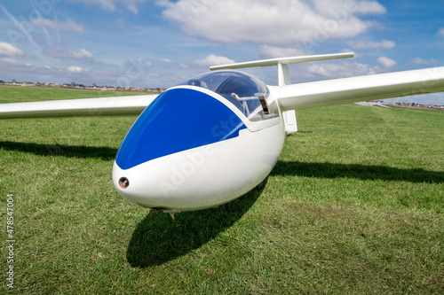 Glider airplane on a grass runway.