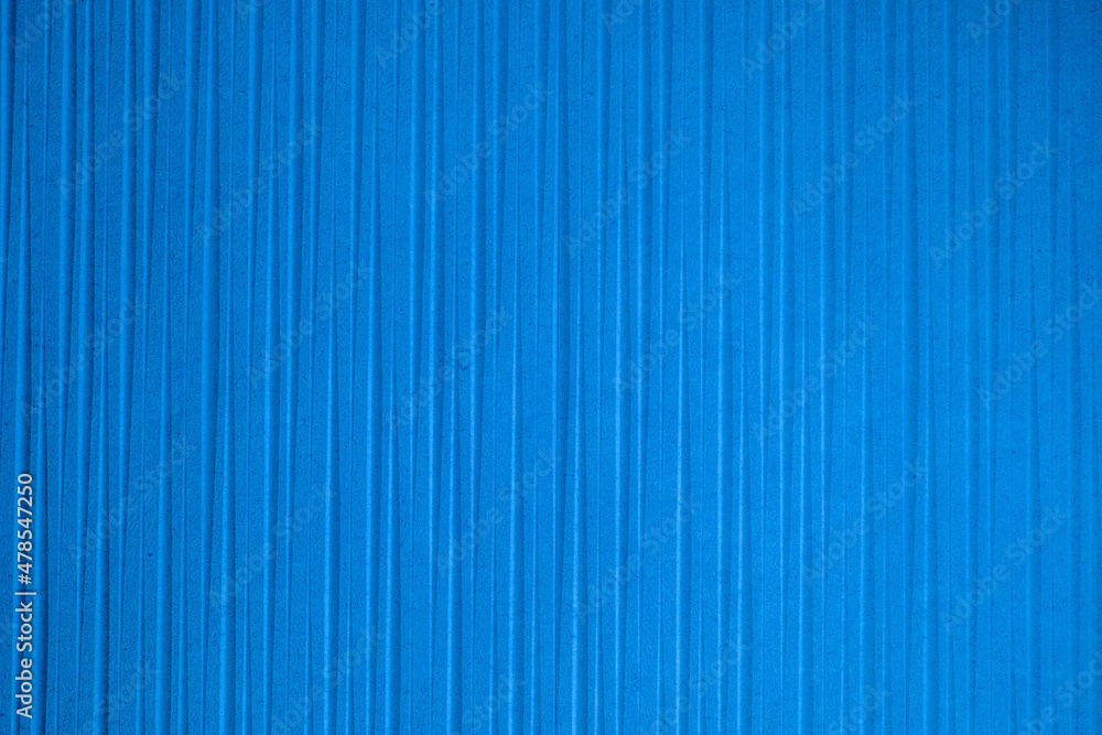 Obraz premium Blue wall with striped decoration ideal for textures and patterns