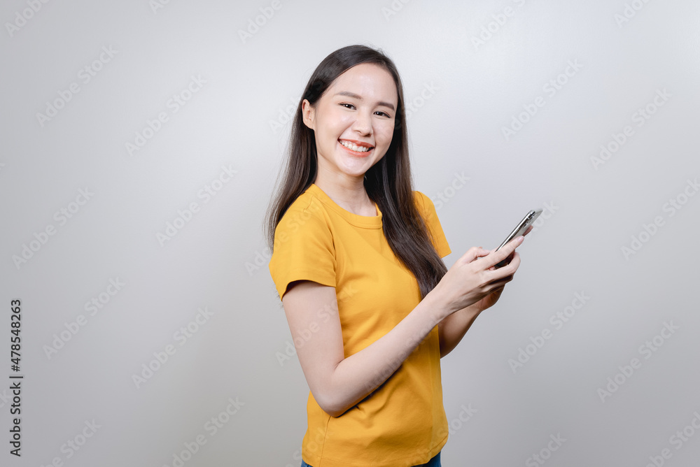 Cheerful asian woman smile when using mobile application Cheerful asian woman smile when using mobile application