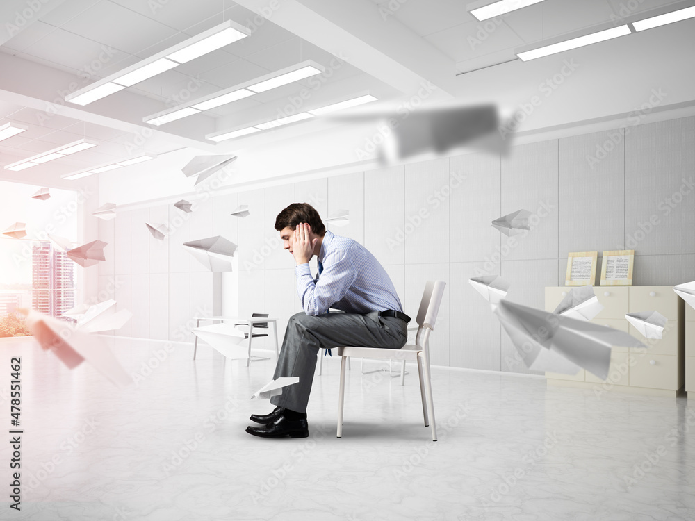 young businessman on chair in office young businessman on chair in office