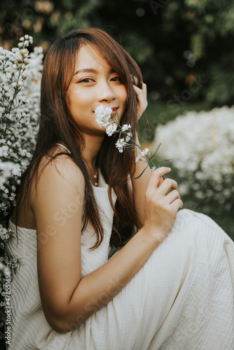 Portrait of thai woman sitting in flower field