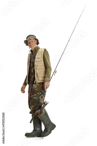 Portrait of young man, professional fishman with fishing rod, spinning and equipment going to river isolated over white studio background
