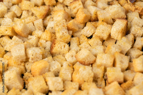 Oven - baked white bread crackers with spices and garlic , selective focus
