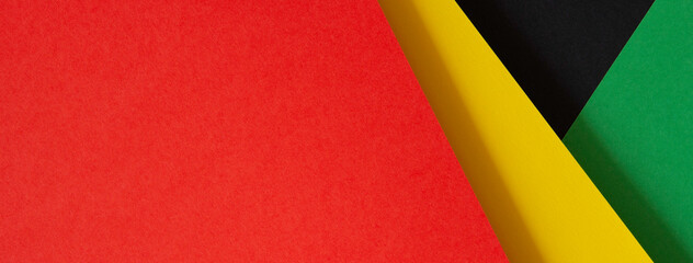 Abstract geometric black, red, yellow, green color paper banner background. Black History Month color background with copy space for text