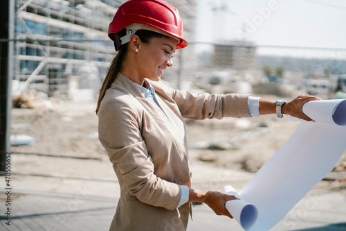 Young beautiful architect. Female engineer with her equipment. Businesswoman working on the new project