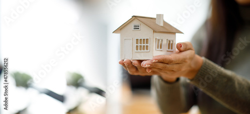 hands holding modern house, family home, homeless shelter and real estate, housing and mortgage crisis, foster home care, family day care, social distancing