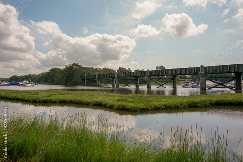 scenic view over tidal river with old railway bridge crossing. 