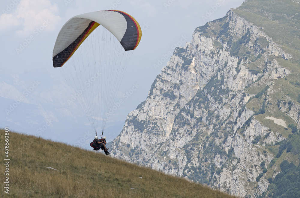 Paraglider with two passengers on a background of blue sky Paraglider with two passengers on a background of blue sky