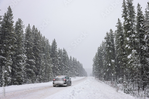 Electric car driving snow mountain road