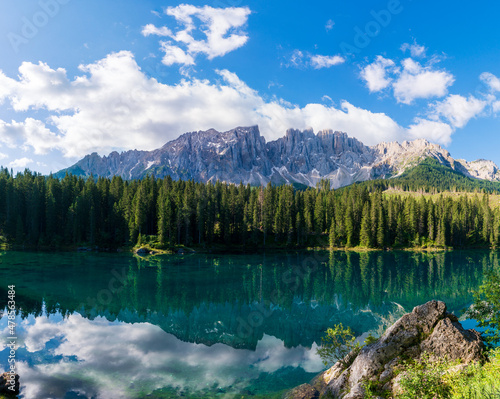bleu lake in the dolomites Italy, Carezza lake Lago di Carezza, Karersee with Mount Latemar, Bolzano province, South tyrol, Italy. Landscape of Lake Carezza or Karersee and Dolomites in background © Martin