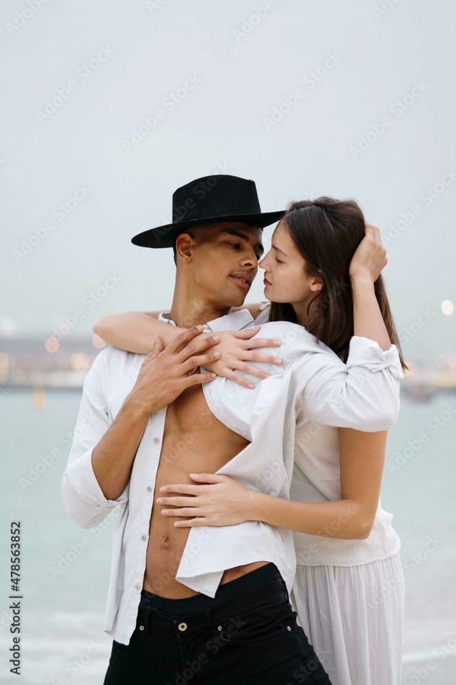 Young couple hugging kissing at the beach