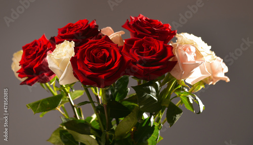 A bouquet of white and red roses flowers as symbol of love and romance against a darkbackground. Pure floral photography.