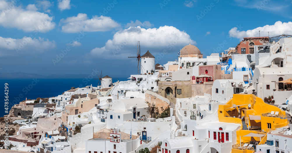Panoramic skyline view of Greek village Oia on Santorini island in Greece on a beautiful vacation day.