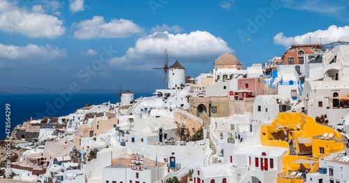 Panoramic skyline view of Greek village Oia on Santorini island in Greece on a beautiful vacation day.