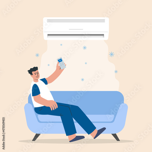 Man turns on the air conditioner cools the air while sitting on the sofa in the room.