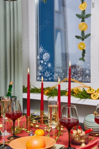 Elegant New Year's table with glasses of wine and candles © Дмитрий Модестов