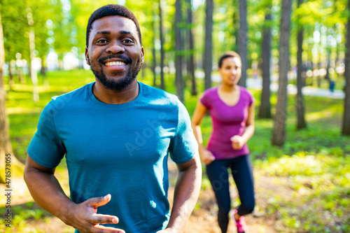 Fit young tired african american couple in sport activity outdoors runs in morning