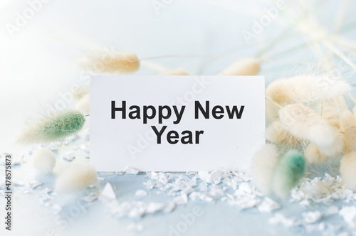 Happy New Year text on a card on a light background