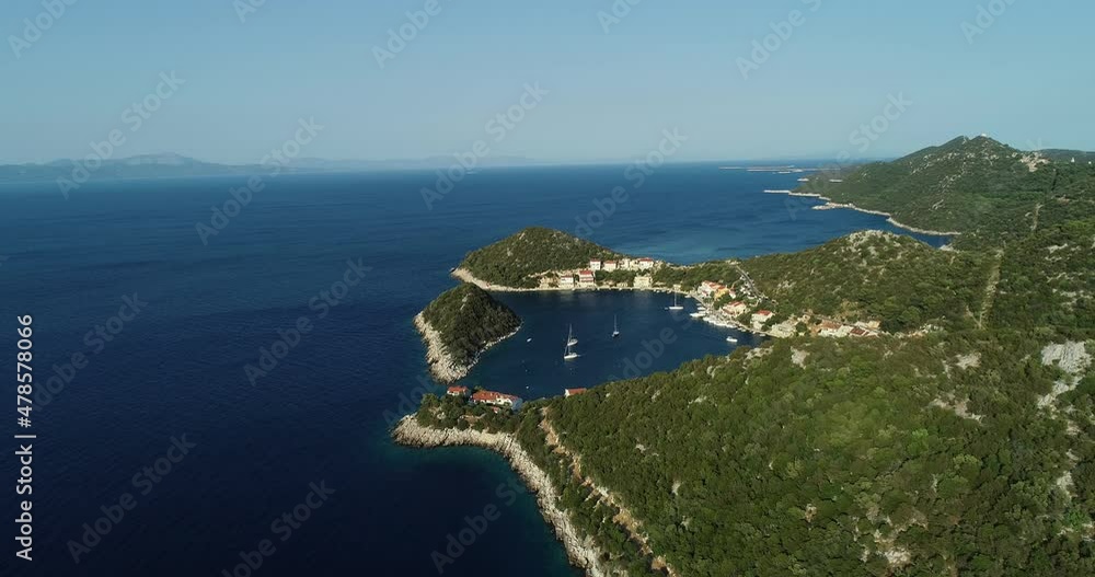 Aerial view of beautiful coastline in Zaklopatica town with a small bay and some sailing boats along the Mediterranean coast, Croatia. Aerial view of beautiful coastline in Zaklopatica town with a small bay and some sailing boats along the Mediterranean coast, Croatia.