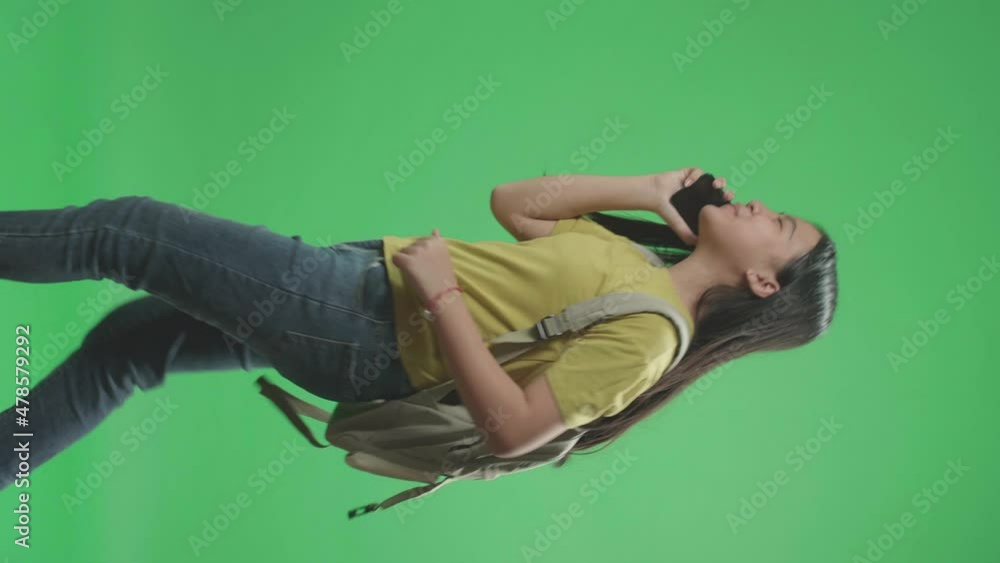 Side View Of Asian Girl Student Talking On Mobile Phone And Running To School On Green Screen Chroma Key
Side View Of Asian Girl Student Talking On Mobile Phone And Running To School On Green Screen Chroma Key