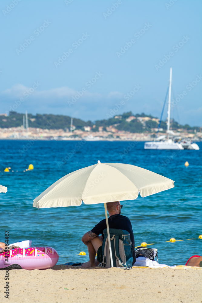 Undentified people sunbathing on sandy beach on French Riviera, Var, France Undentified people sunbathing on sandy beach on French Riviera, Var, France