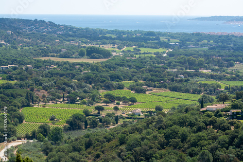View on valley and sea from ancient french village Grimaud, touristic destination with ruines fortress castle on top, Var, Provence, France
