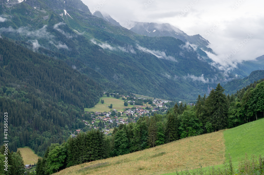 Panoramic view on mountain villages, green forests and apline meadows near Saint-Gervais-les-Bains, Savoy. France