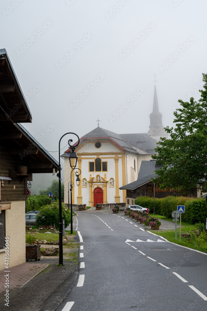 View on mountain chapel in foggy small village near Saint-Gervais-les-Bains, Savoy, France