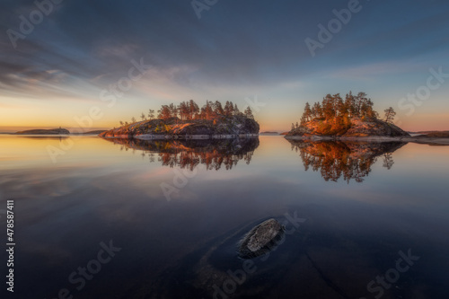 Magnetic and colorful view of the islands. Beauty of summer nature concept background. Stunning view of the islands on a sunny early morning with dramatic clouds.Republic of Karelia. Ladoga lake