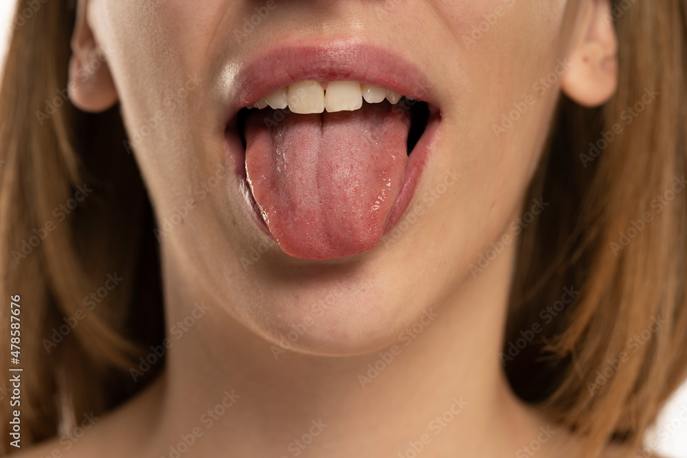 Cropped image of young woman showing tongue Cropped image of young woman showing tongue
