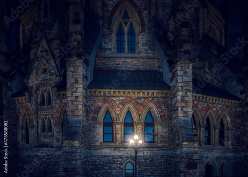 Exterior of the gothic Canadian Library of Parliament in Ottawa at night illuminated by globe lights, nobody