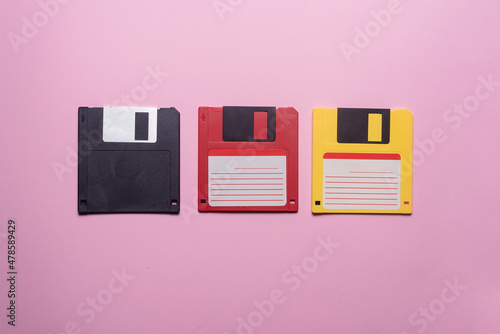 Various floppy disks on the purple flat lay background. photo