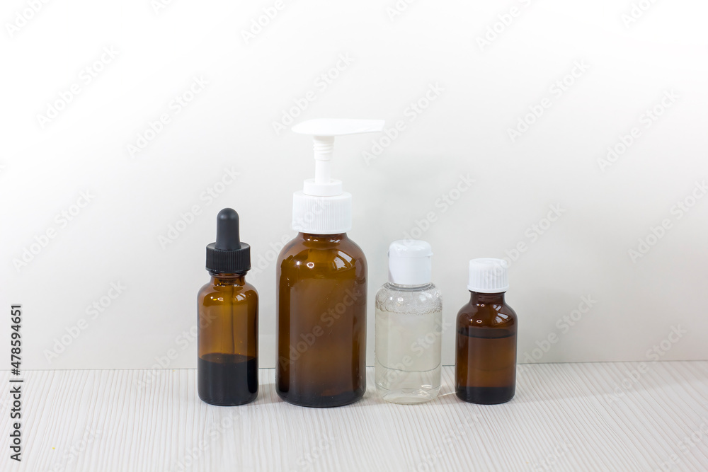 Various glass bottles for cosmetics, essential oils or other liquids isolated on a white background. Various glass bottles for cosmetics, essential oils or other liquids isolated on a white background.