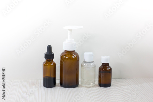 Various glass bottles for cosmetics, essential oils or other liquids isolated on a white background.