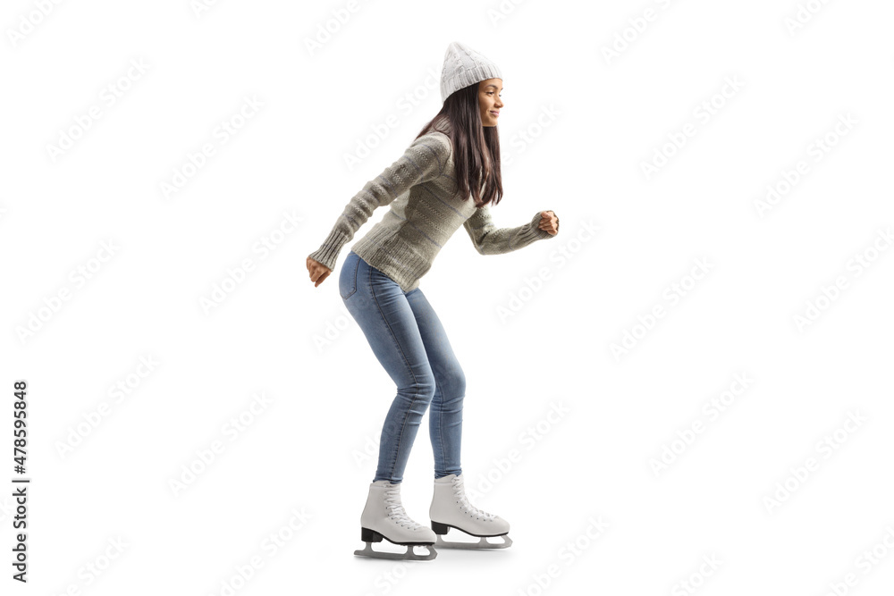 Full length profile shot of a young casual woman ice skating Full length profile shot of a young casual woman ice skating