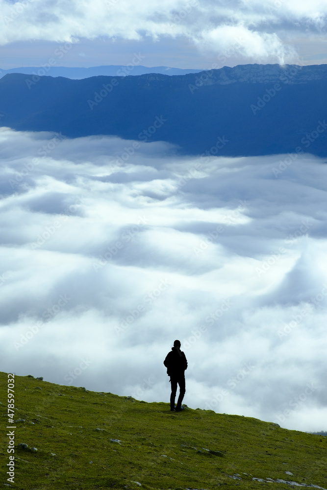Man in the Aralar mountain range, with a sea of clouds over Sakana, Navarre