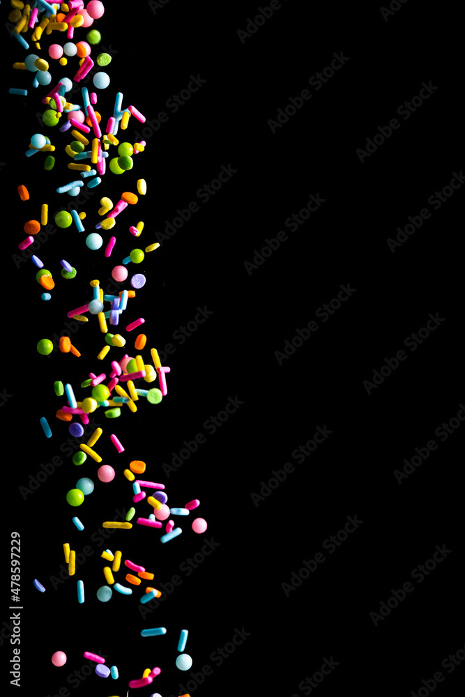 Sprinkles falling on a dark background Sprinkles falling on a dark background