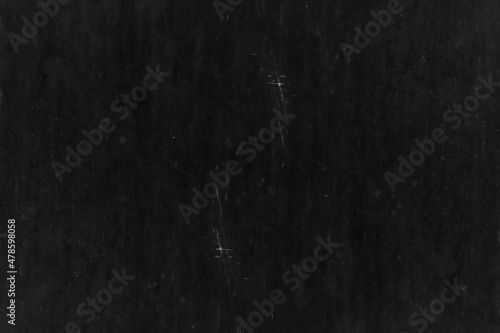 Old black metal sheet with scratches and spots for texture background