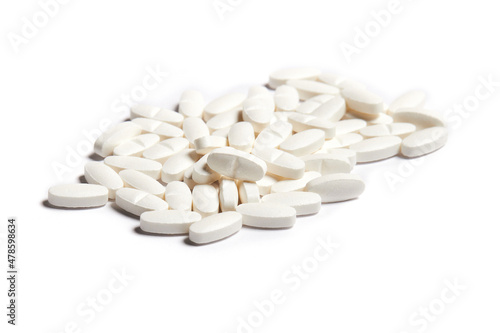 White pills on the white background. Health care concept