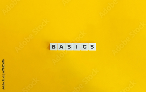 Basics Word on Block Letter Tiles on bright orange background. Minimal aesthetics. photo