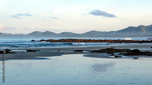 Rocks exposed on the beach, just after sunrise, in Tamarindo, Costa Rica