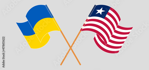 Crossed and waving flags of Ukraine and Liberia