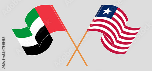 Crossed and waving flags of the United Arab Emirates and Liberia