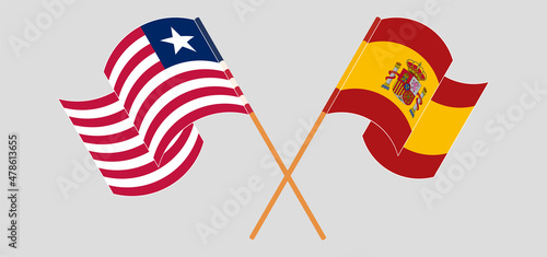 Crossed and waving flags of Liberia and Spain