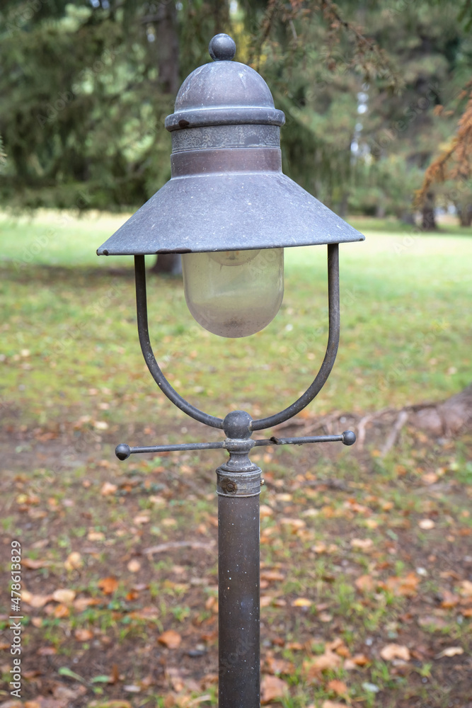 Vintage lantern on the background of a beautiful park