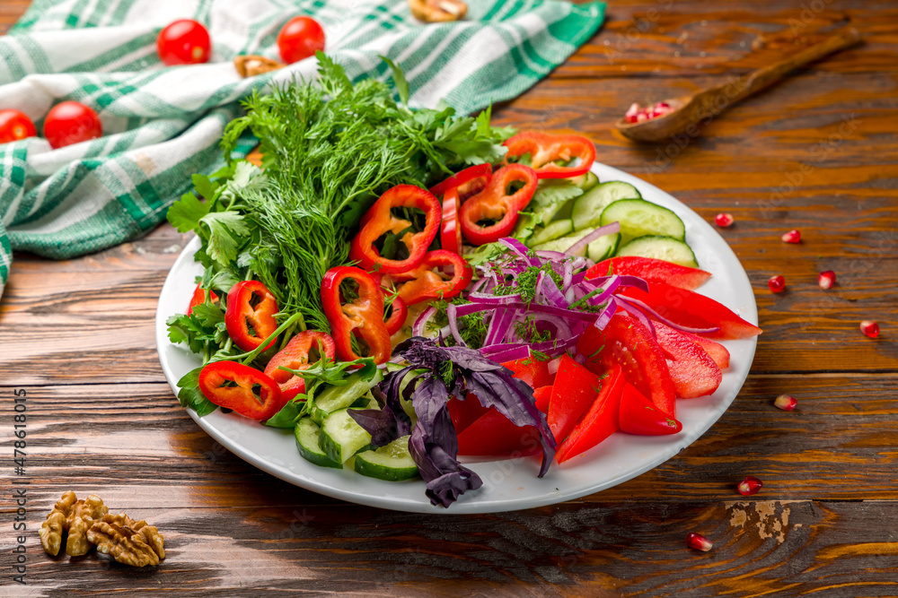 slicing fresh vegetables on a plate on wooden table slicing fresh vegetables on a plate on wooden table