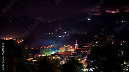 Old town in the middle of a mountain at night with a thunder photo