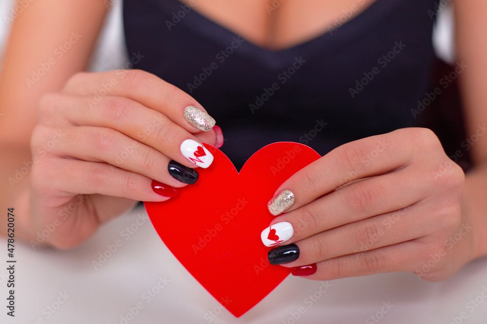 Beautiful female hands with romantic manicure nails, holding red heart, Valentine's day design Beautiful female hands with romantic manicure nails, holding red heart, Valentine's day design