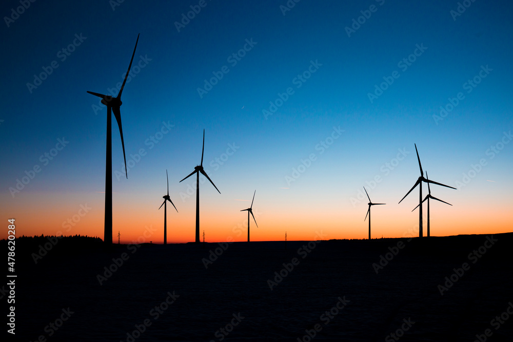 Obraz premium Wind turbines farm at sunset