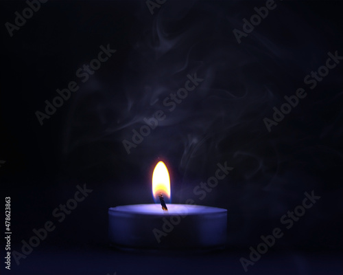 Burning candle in the dark